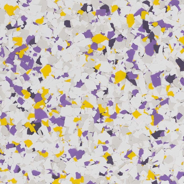 A decorative epoxy flooring chip blend featuring a mix of white, grey, purple, and yellow fragments.