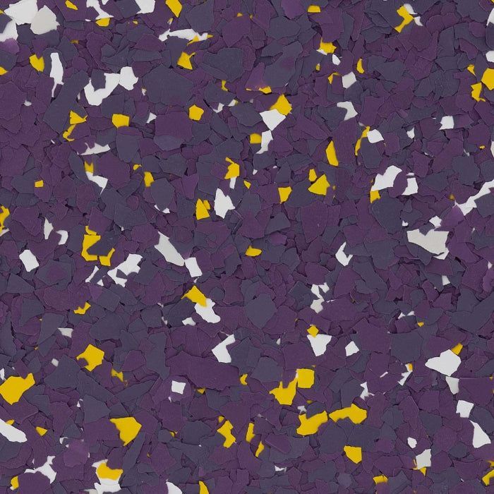 A close-up of decorative floor flakes in a pattern of deep purple, bright yellow, and white against a dark background.