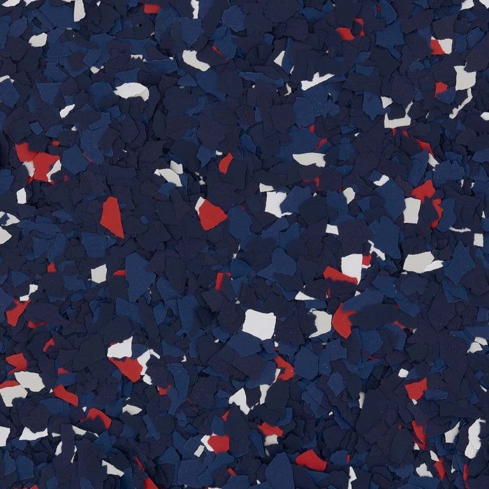 A pattern of small, jagged paint chips in shades of dark navy, bright red, and white, typically used for floor coating.