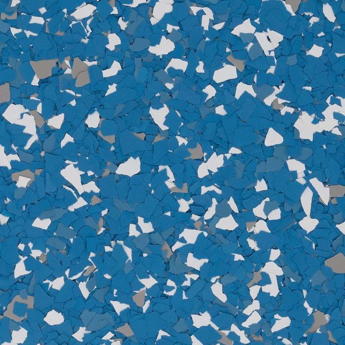 A close-up of a decorative flooring pattern featuring a dense mix of blue, light gray, and white vinyl color chips.