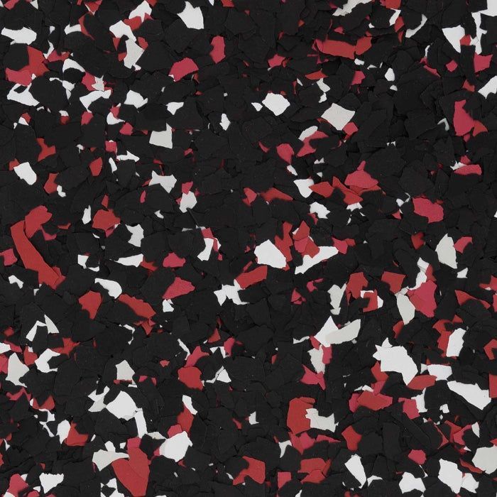 A close-up of a speckled floor coating texture featuring a mix of black, white, and red vinyl flakes.