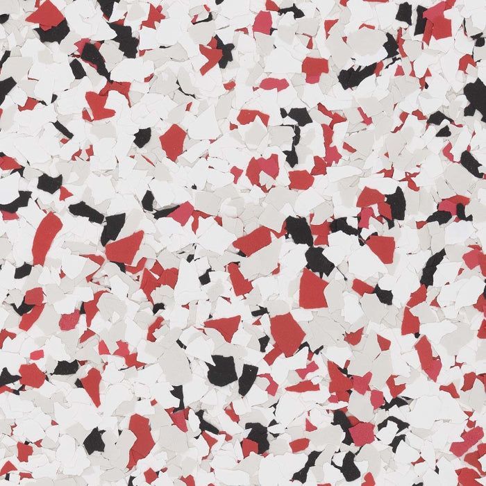 A decorative epoxy flooring chip blend featuring a speckled pattern of white, light gray, black, and red flakes.