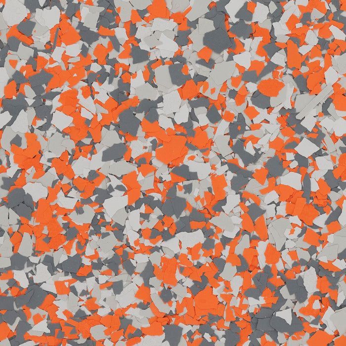A pattern of speckled vinyl flooring chips in orange, light grey, and charcoal grey.