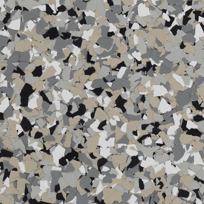 A pattern of multicolored vinyl flakes in shades of grey, black, white, and tan, typically used for decorative flooring.
