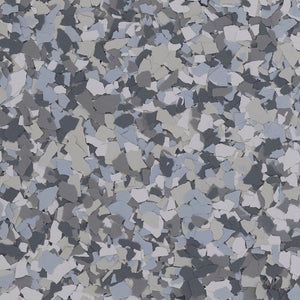 A close-up of a decorative flooring finish featuring a dense blend of grey, white, and charcoal-colored paint chips.