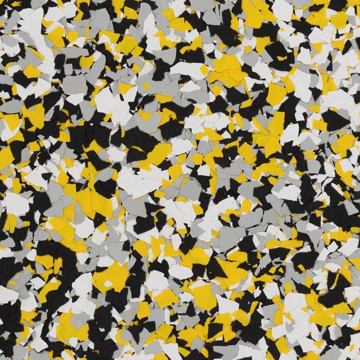 A speckled pattern of jagged, multi-sized flakes in yellow, gray, black, and white colors, resembling decorative flooring.