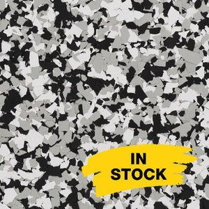 A background of speckled black, gray, and white vinyl floor chips with a yellow 
