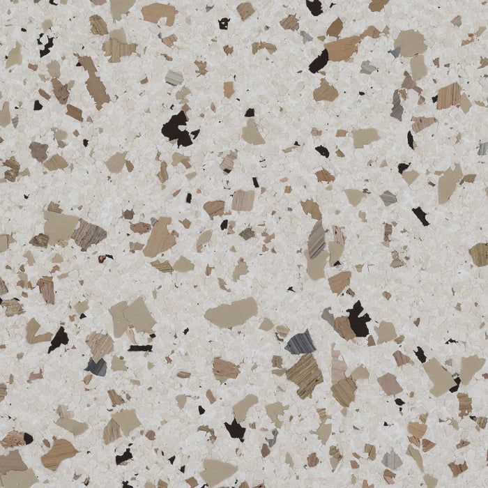 A speckled texture with tan, brown, and black flakes over an off-white background, resembling epoxy or vinyl flooring.