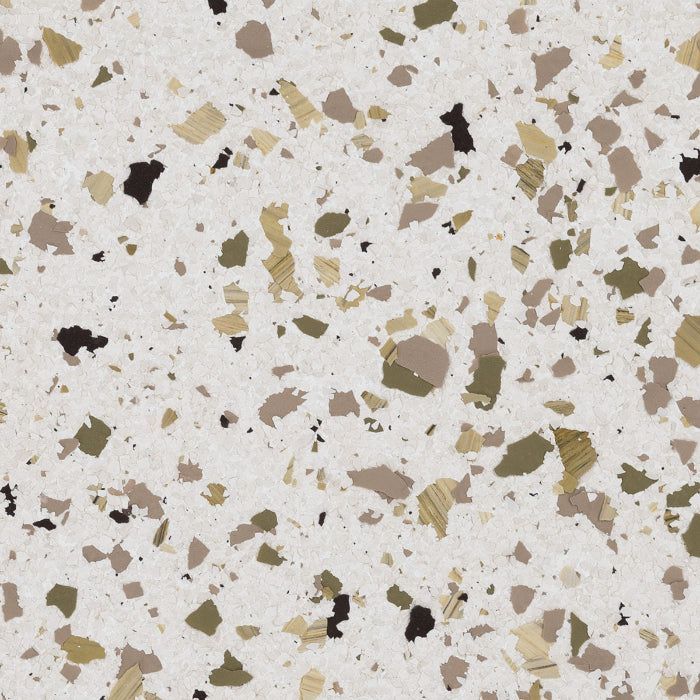 A light-colored, speckled surface texture featuring scattered chips in shades of olive green, tan, brown, and black.