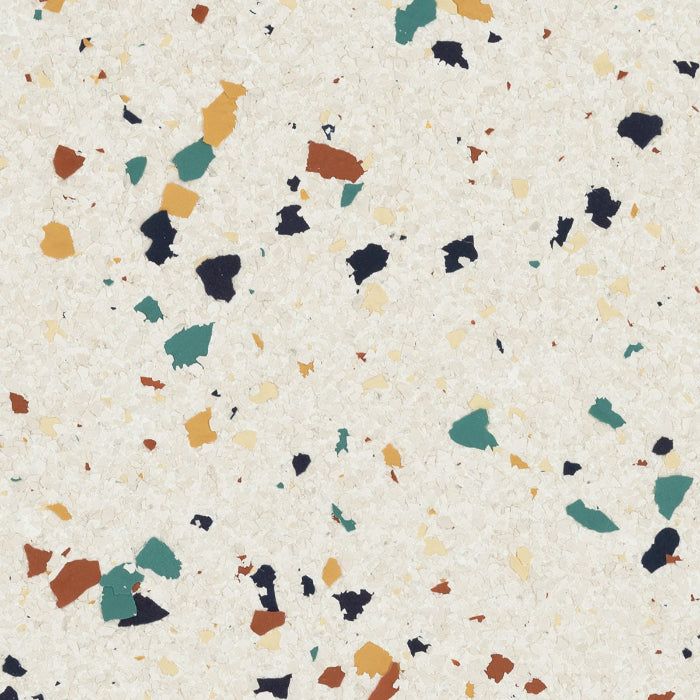A pattern of scattered, multi-colored stone chips in blue, ochre, and rust on a textured, off-white background.