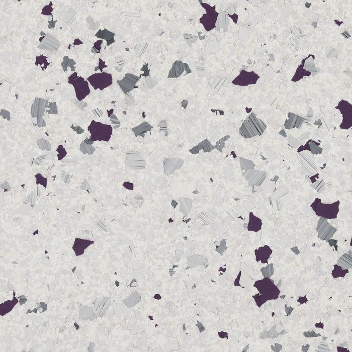 A speckled floor pattern with dark purple and grey chips on a light grey, textured background.