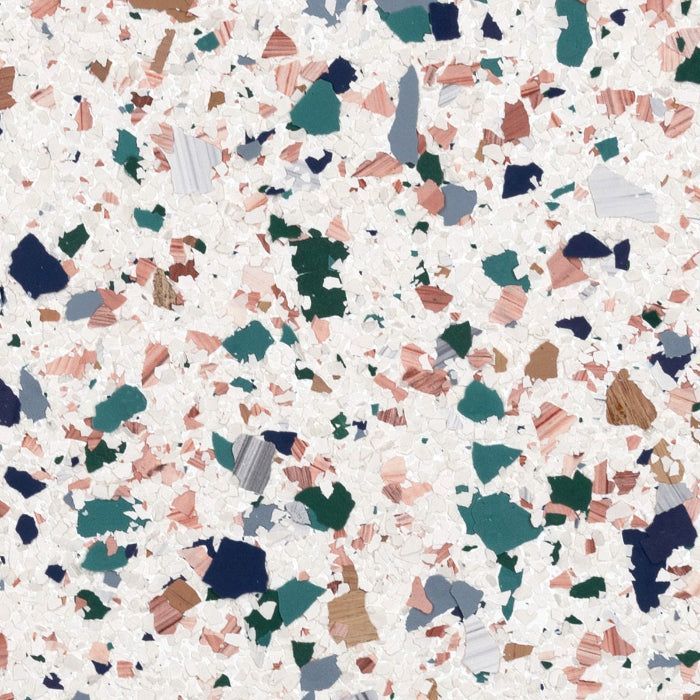 A terrazzo pattern with multi-colored stone chips in shades of green, blue, and salmon against a white speckled background.
