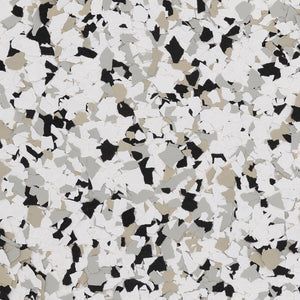 A close-up of a decorative flooring finish featuring a dense mix of white, black, gray, and tan vinyl flakes.