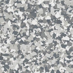 A decorative floor flake texture featuring a speckled mix of white, light gray, and dark charcoal gray chips.
