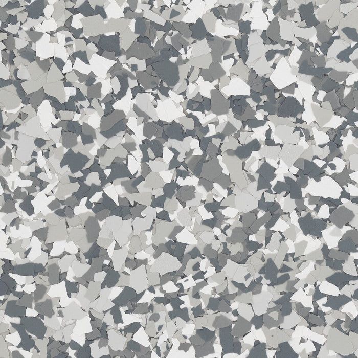A texture of overlapping gray, charcoal, and white paint flakes used for epoxy flooring.