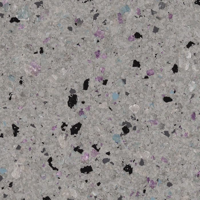 A light gray surface with speckled flecks of black, purple, and blue throughout.