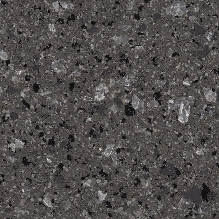 A dark grey composite stone surface with small, speckled black and white crystalline chips throughout.