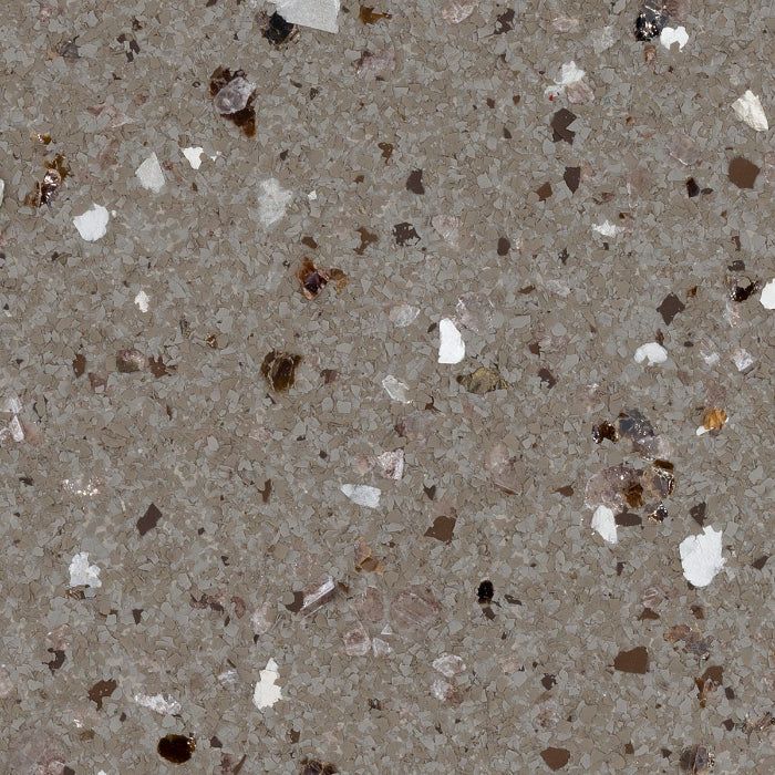 A textured, taupe-colored composite surface featuring scattered, irregular flecks of white, dark brown, and tan.