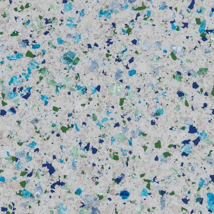 A close-up texture featuring a white base speckled with blue and green chips.