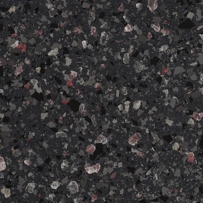 Dark charcoal gray surface with a speckled, multi-colored aggregate pattern of black, white, and reddish mineral chips.