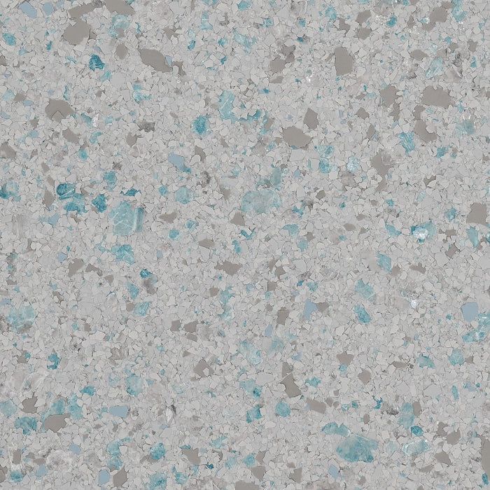 A close-up of a speckled floor texture with light gray, dark gray, and turquoise blue chips.