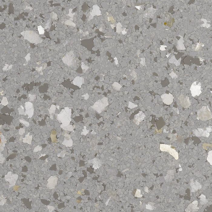 Close-up texture of grey flooring with scattered white, light grey, and dark charcoal stone-like flecks.