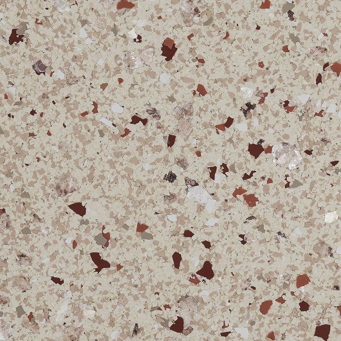 A beige speckled flooring surface with embedded chips in shades of dark brown, tan, and cream.