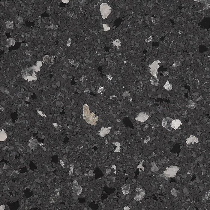 A dark gray, speckled stone or terrazzo-style texture with scattered white, light gray, and black flecks.