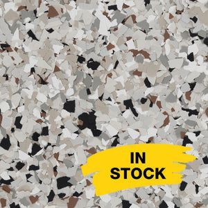 A multi-colored decorative vinyl flake floor coating in tan, gray, white, and black, with an 