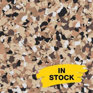 A close-up of tan, brown, black, and white decorative floor flakes with a yellow 