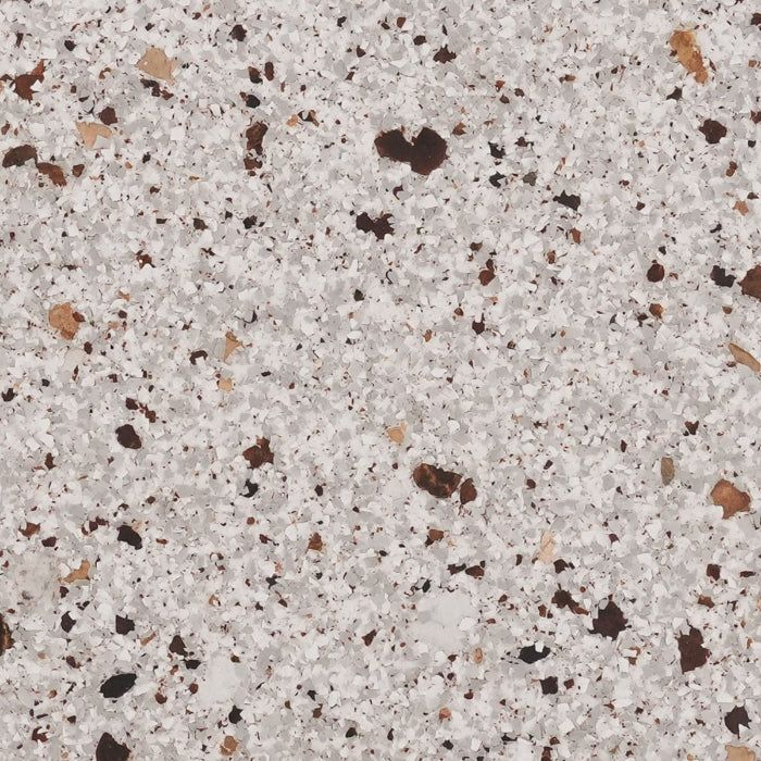 A close-up texture of granite-style stone featuring white, grey, black, and tan flecks and specks.