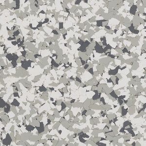 A close-up texture of gray, white, and charcoal-colored vinyl floor flakes, creating a speckled, granite-like pattern.