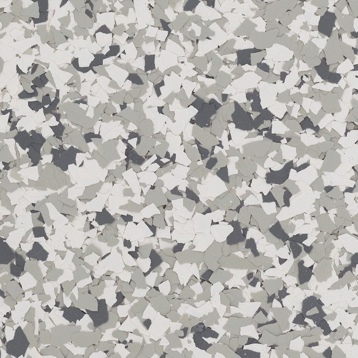 A floor surface texture featuring a mix of grey, dark grey, and white paint flecks in a speckled, random pattern.