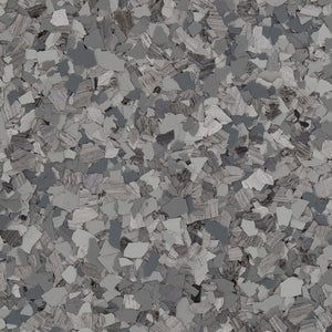 A close-up of grey, black, and white decorative vinyl floor chips in a dense, speckled pattern.