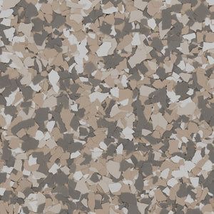 A close-up of decorative vinyl paint chips in shades of tan, dark gray, and off-white for epoxy flooring.