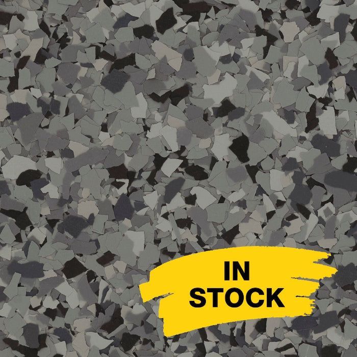 Gray and black granite-look epoxy floor flakes with a yellow 