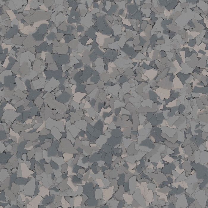 A close-up of a grey, speckled epoxy flooring texture with varied light and dark grey paint chips.