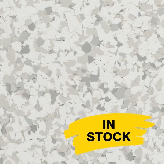 A close-up of a white and gray speckled floor flake texture with a yellow 