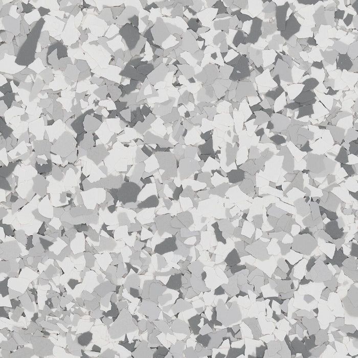 A textured floor covering with a speckled, mosaic pattern in varying shades of white, gray, and dark charcoal.