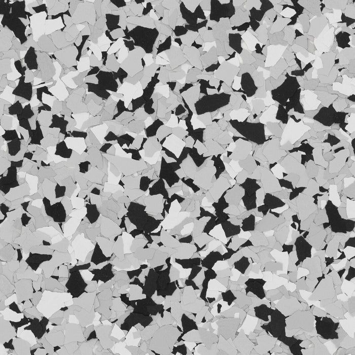 A monochromatic pattern of overlapping black, gray, and white irregular flakes, typical of a decorative floor coating.