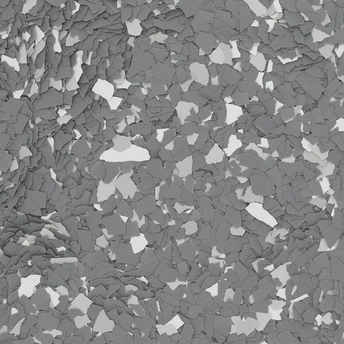 A close-up of a speckled floor coating texture featuring a mix of dark gray, light gray, and white flakes.