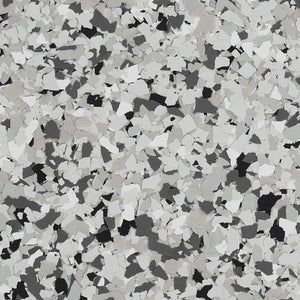 A close-up of a decorative flooring finish featuring a dense pattern of black, gray, and white vinyl color chips.