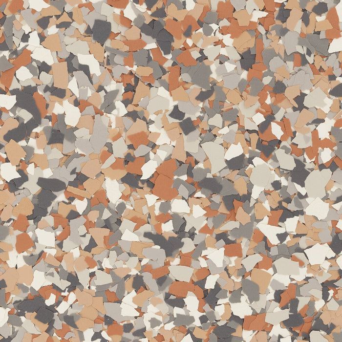A textured surface covered in a multi-colored vinyl flake broadcast in shades of brown, tan, gray, and off-white.