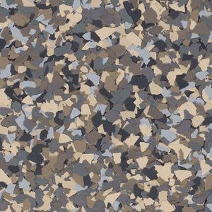 A close-up of a decorative flooring material consisting of tan, grey, charcoal, and white vinyl color chips.