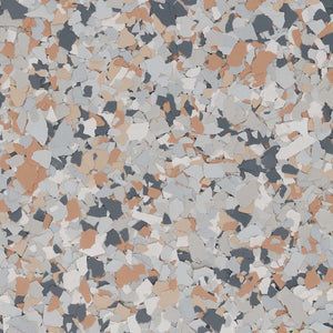 Decorative epoxy floor coating with a speckled blend of charcoal, light gray, white, and tan color chips.