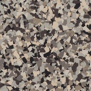 A decorative epoxy floor coating featuring a dense, randomized mixture of tan, charcoal, gray, and cream-colored flakes.