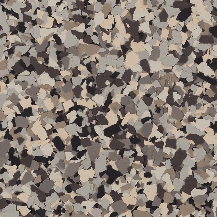 Decorative epoxy floor coating with a speckled pattern of beige, grey, and black vinyl flakes.