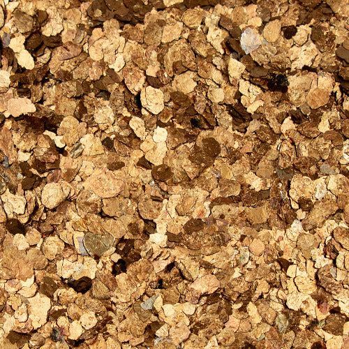 A close-up texture background of light brown, tan, and dark brown metallic glitter flakes of varying shapes and sizes.