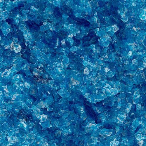 A close-up of coarse, vibrant blue crystals or crushed glass fragments with varying shades and reflective surfaces.