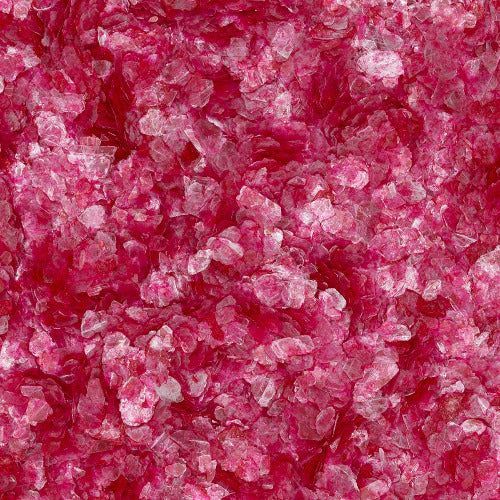 A close-up view of vibrant pink, jagged, translucent crystals or crushed glass fragments.